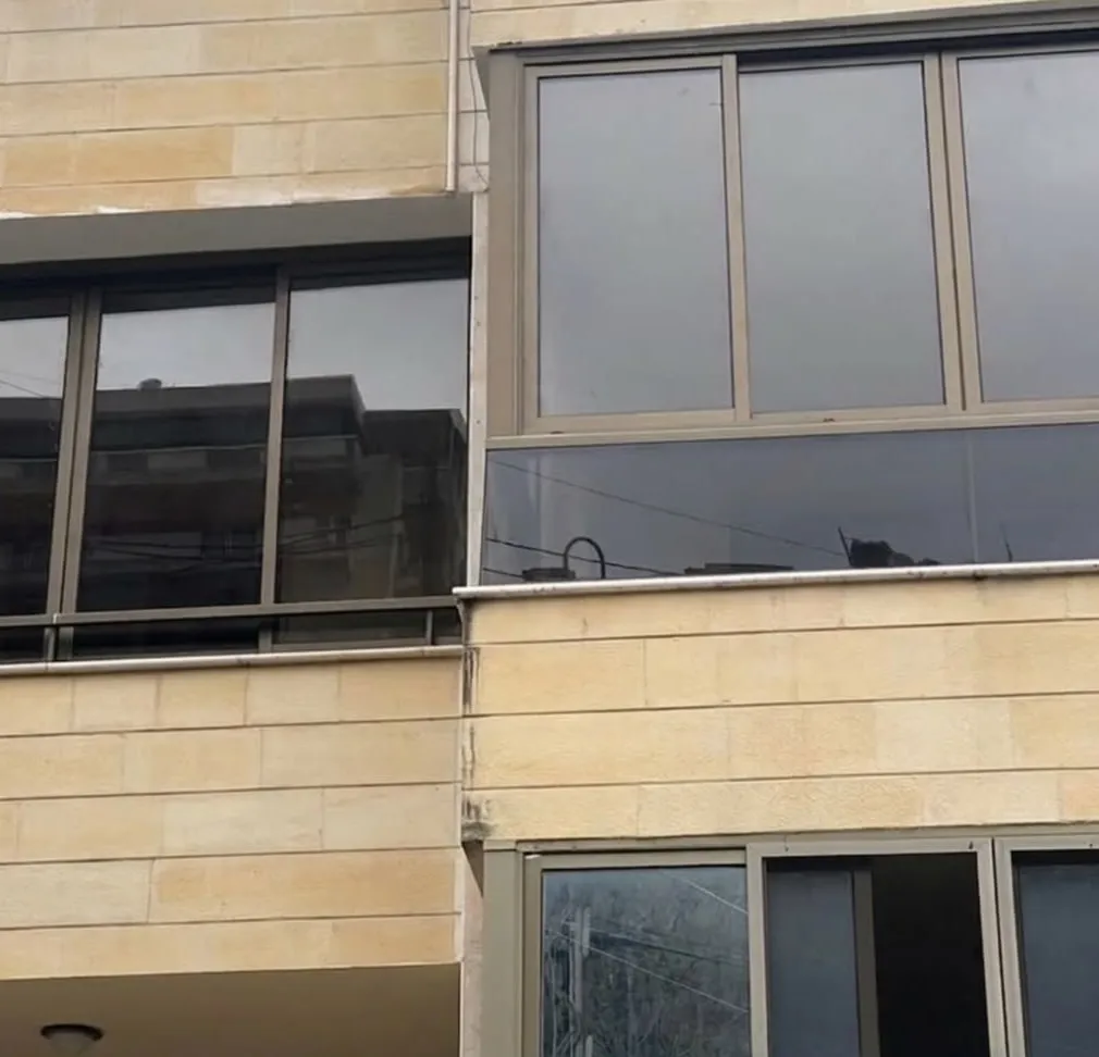 Aluminium enclosures set into a cut-stone apartment block
